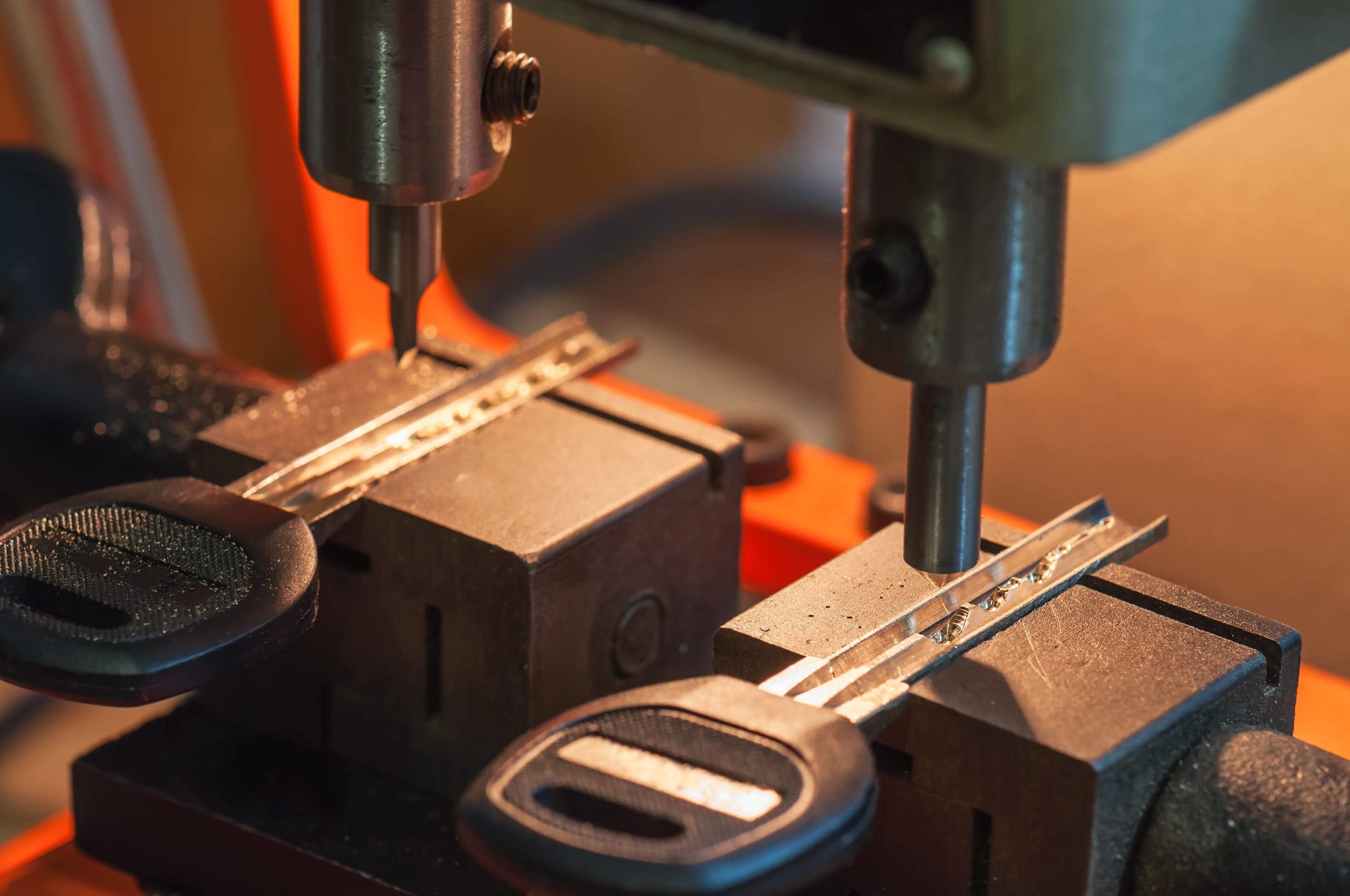 Master keys being cut by a machine.