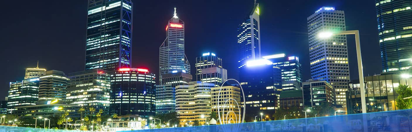 Driving into the commercial part of Perth city lit up with night lights.