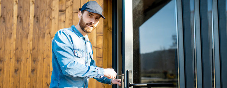 A qualified locksmith fixing a door.