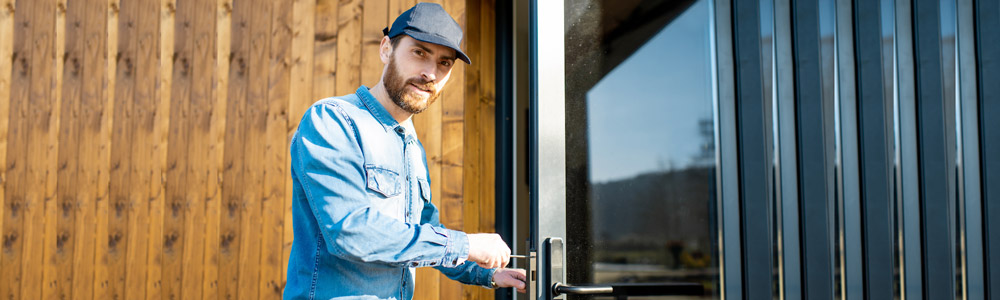 A qualified locksmith fixing a door.