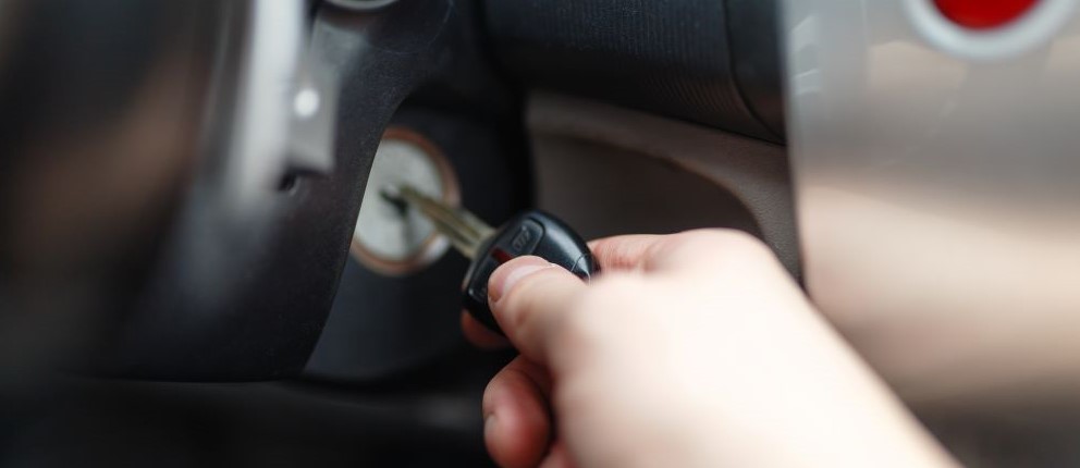 A hand inserting key into ignition.