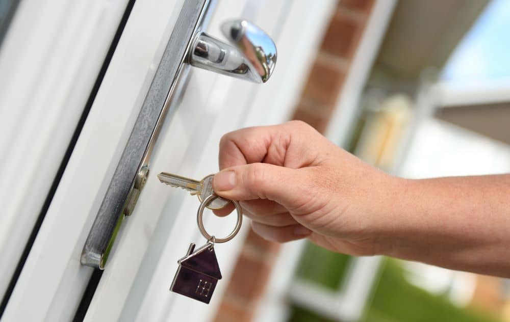 Opening door with house key.