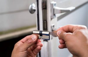 Locksmith replacing door lock.