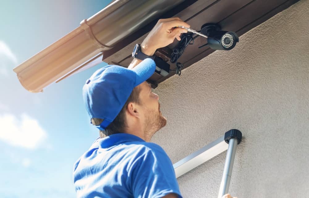 Technician installing security camera.