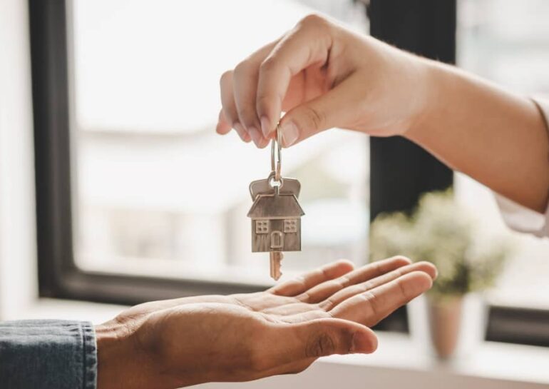 Landlord handing over key to tenant.