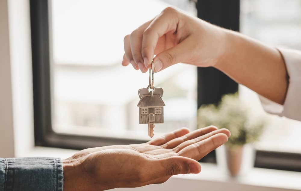 Landlord handing over key to tenant.