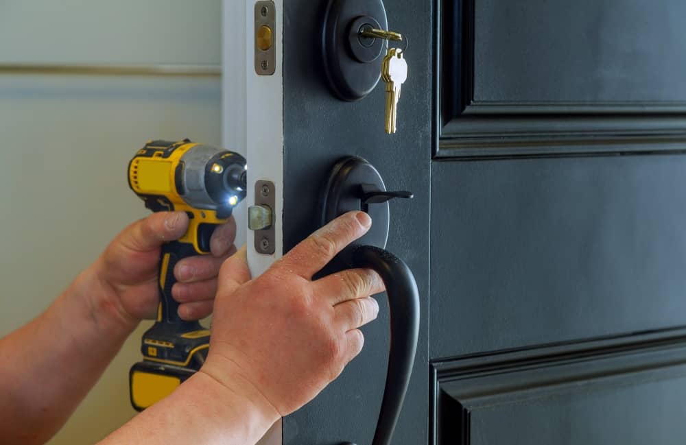 Locksmith repairing door lock.