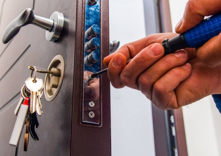 professional locksmith repairing lock on a door