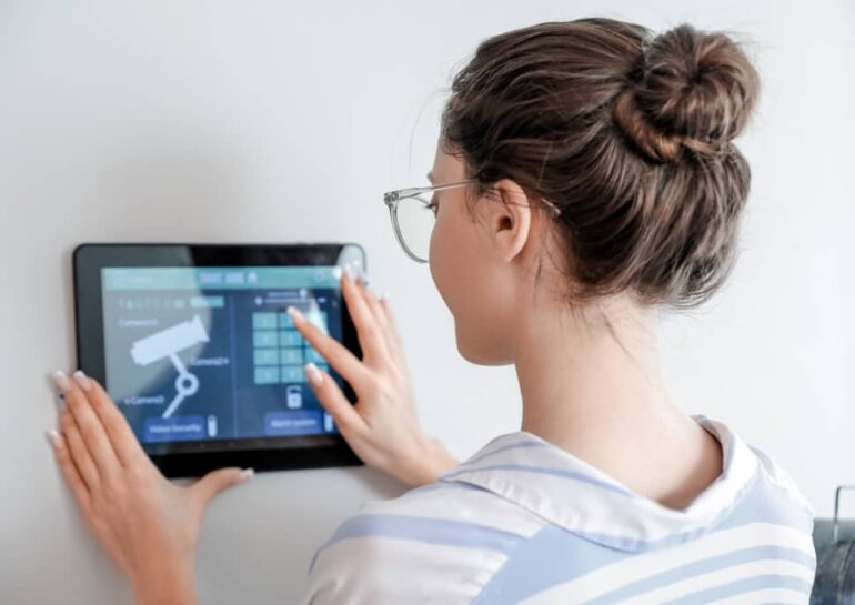 lady using a tablet to control her security cameras