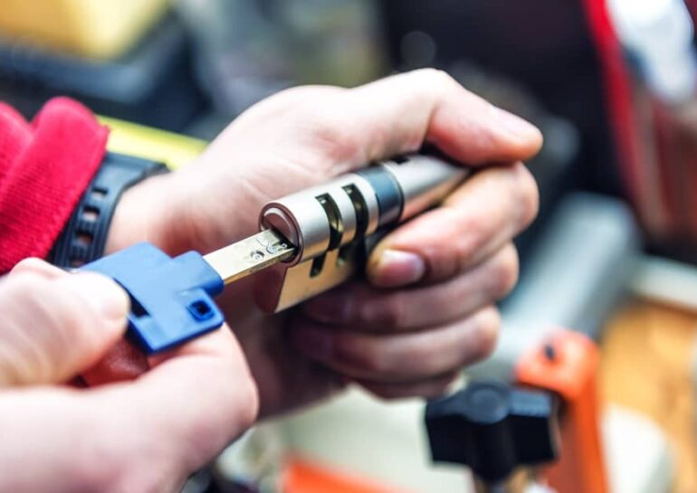 locksmith testing a key inside a door lock cylinder