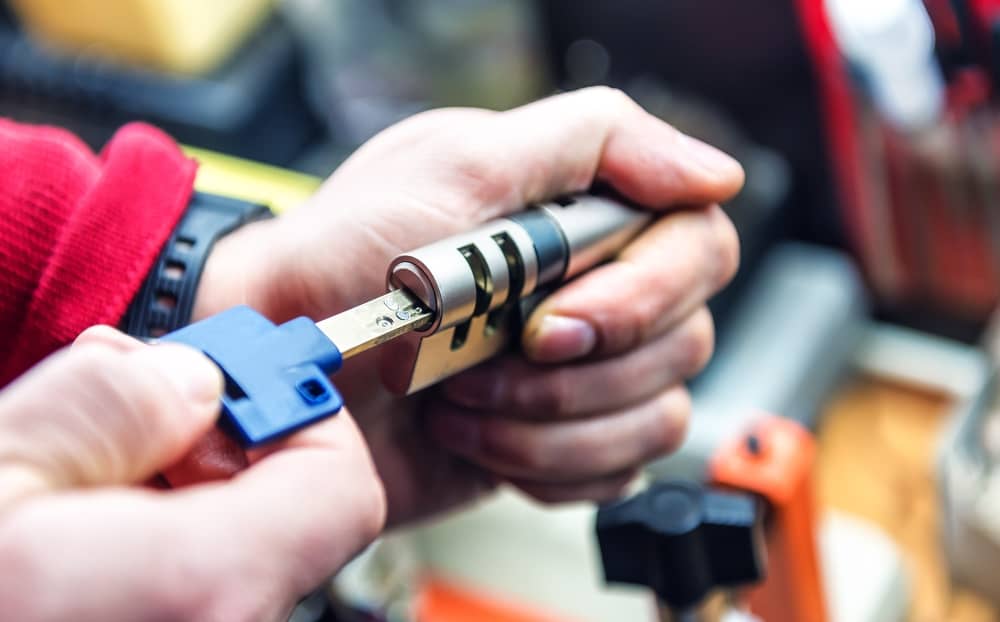 locksmith testing a key inside a door lock cylinder