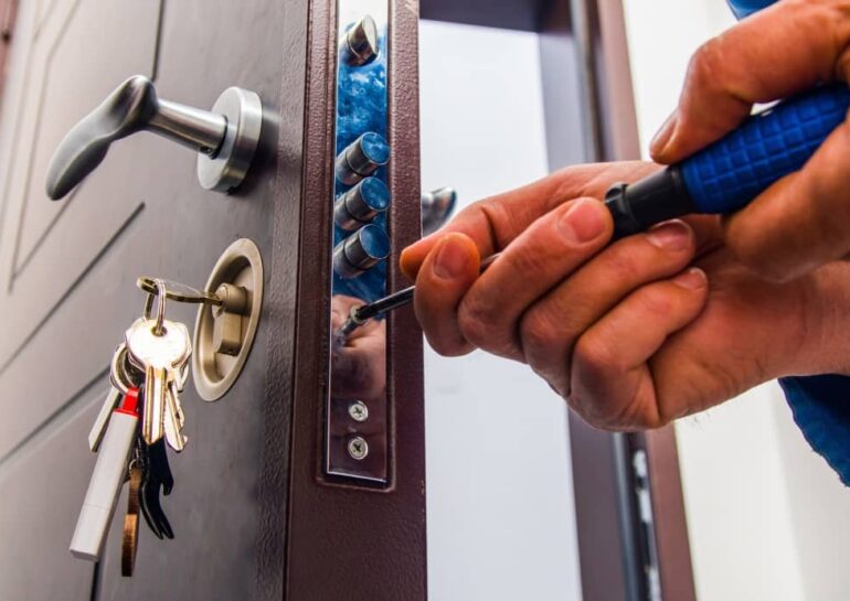 Locksmith repairing door lock.