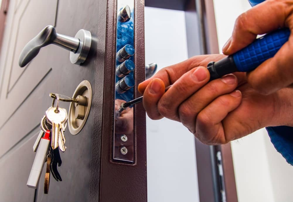 Locksmith repairing door lock.